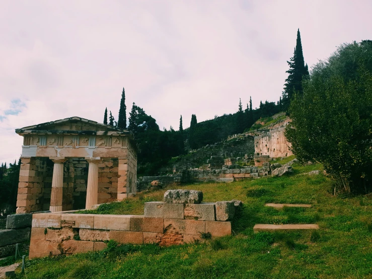 an ancient ruins sitting on top of a hill