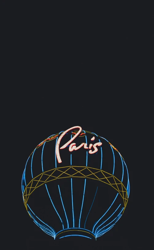 a blue neon sign for paris in the dark