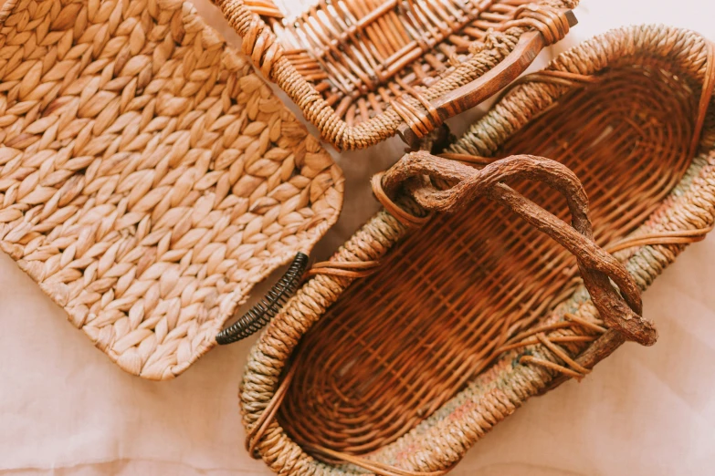 three woven baskets lay on a white table