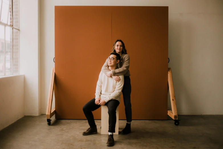 a man sitting on top of a woman while she looks up