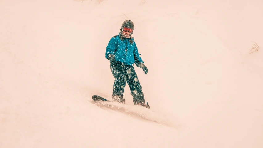 a person riding down a hill on a snowboard