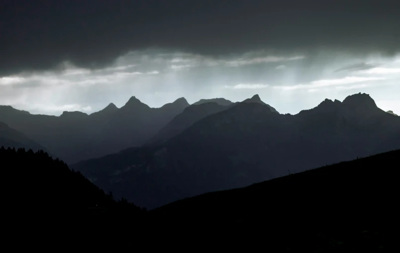 there is an image of mountain range in the dark