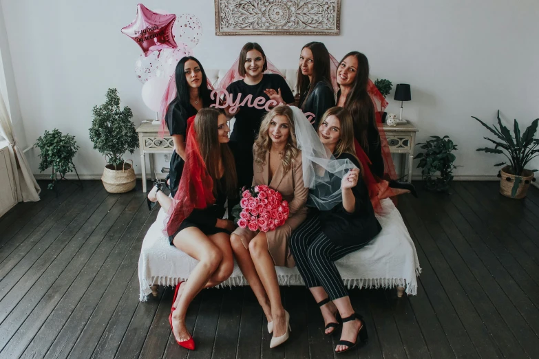 women in lingerie outfits sitting on a bed