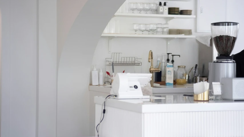 white bathroom with a blender, towel and other things