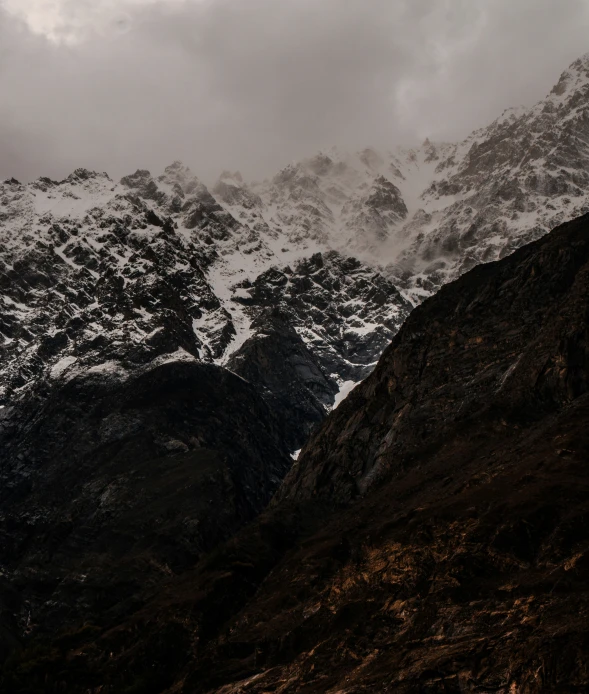 the top of the snowy mountain shows a dark landscape