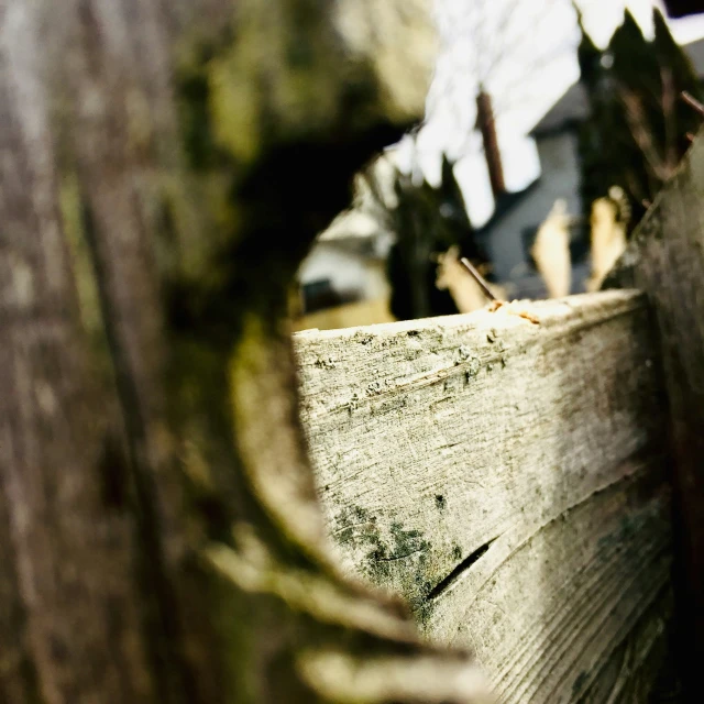 an old, dirty wooden plank that is fenced off