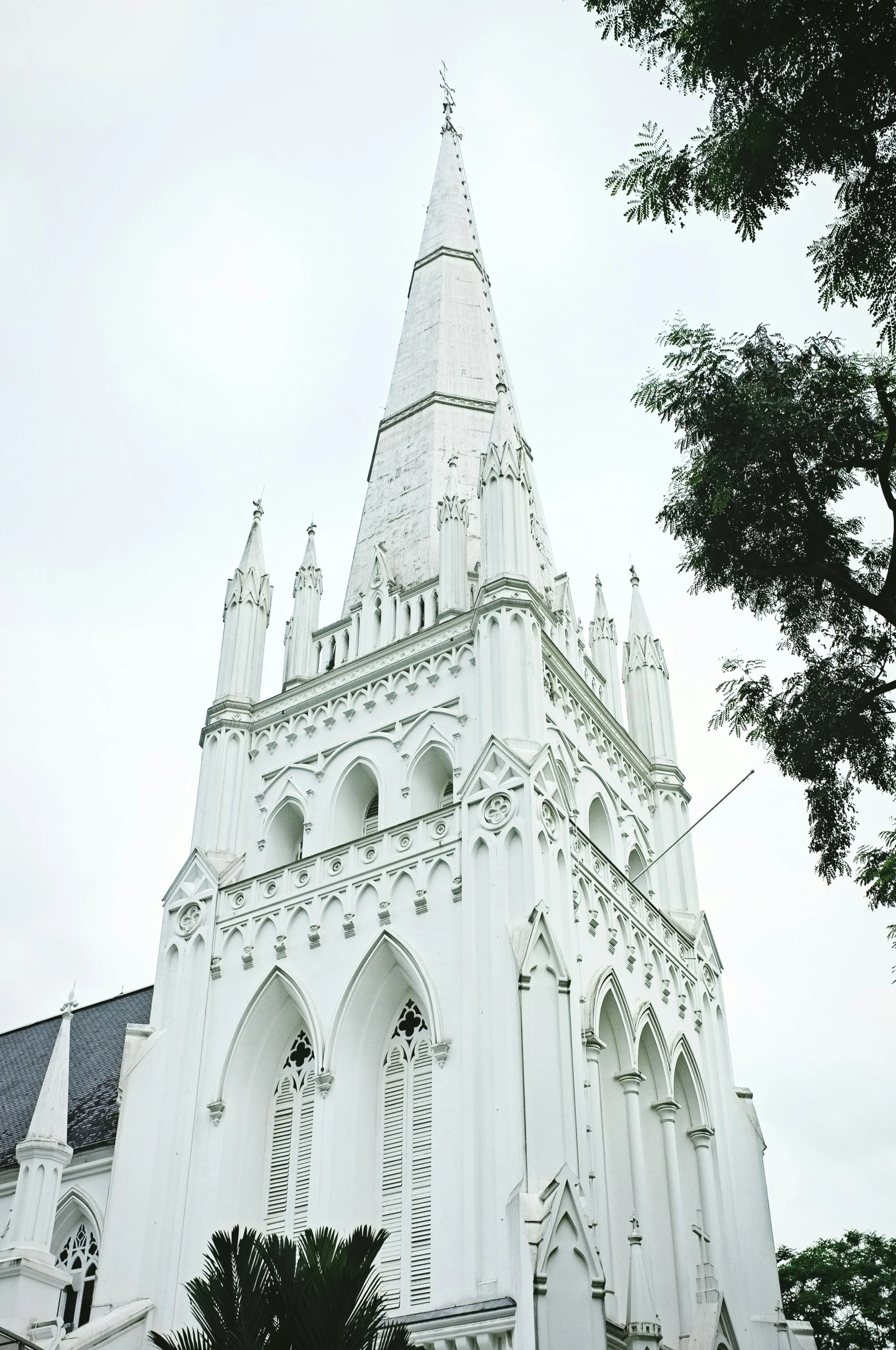 an elaborate tower with clocks sits on a cloudy day