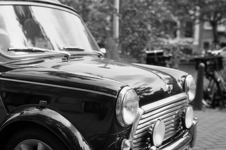 a black and white po of a car parked on a brick road