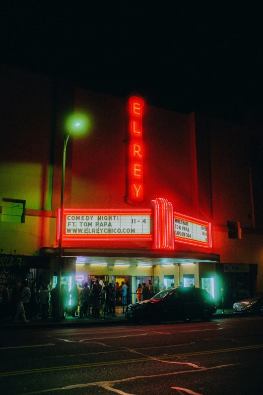 there is people waiting outside of the theater