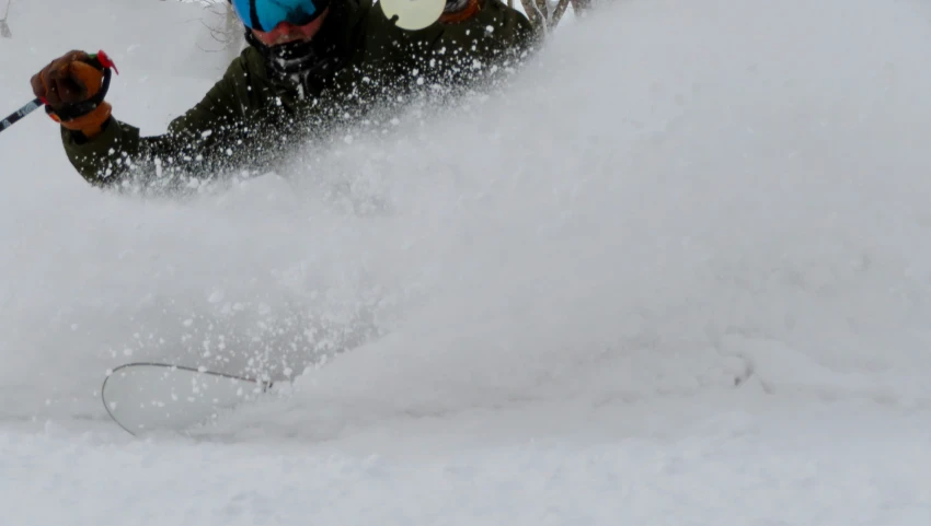 a person skiing down a snow covered slope