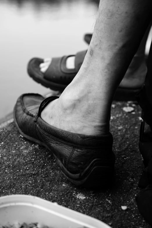 a person with shoes sitting on a ledge