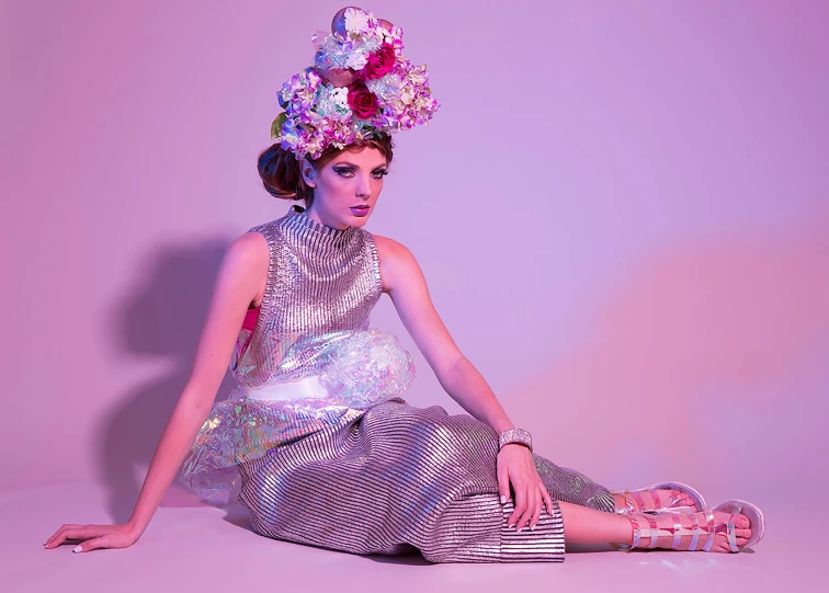 a woman in a silver dress and flower headdress