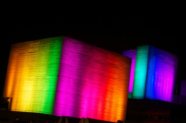 a colorful light curtain on top of an outside building