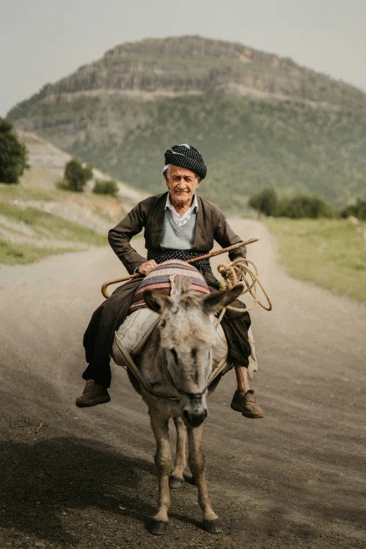 a man riding on the back of a white donkey