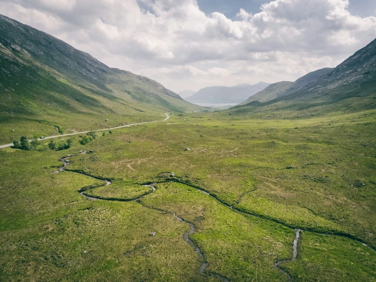 an aerial view of mountains and rivers in the valley