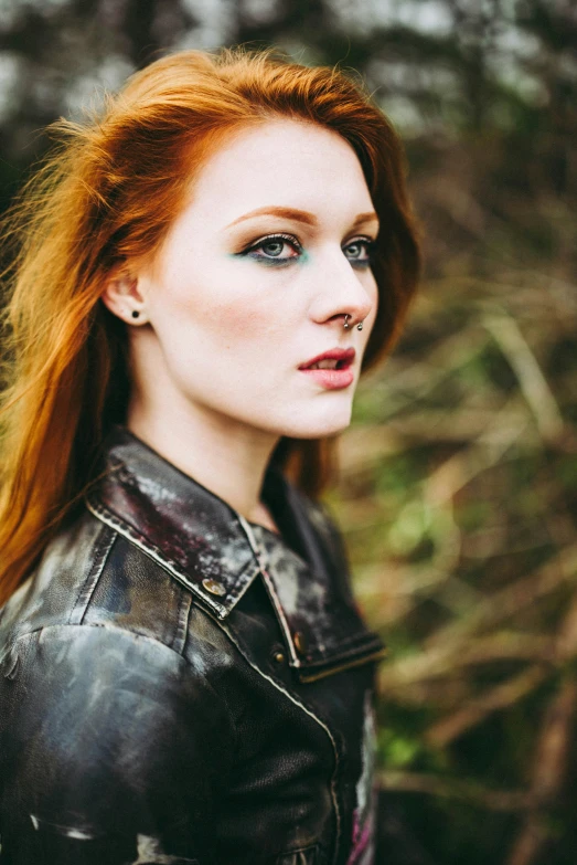 woman with red hair and black leather jacket