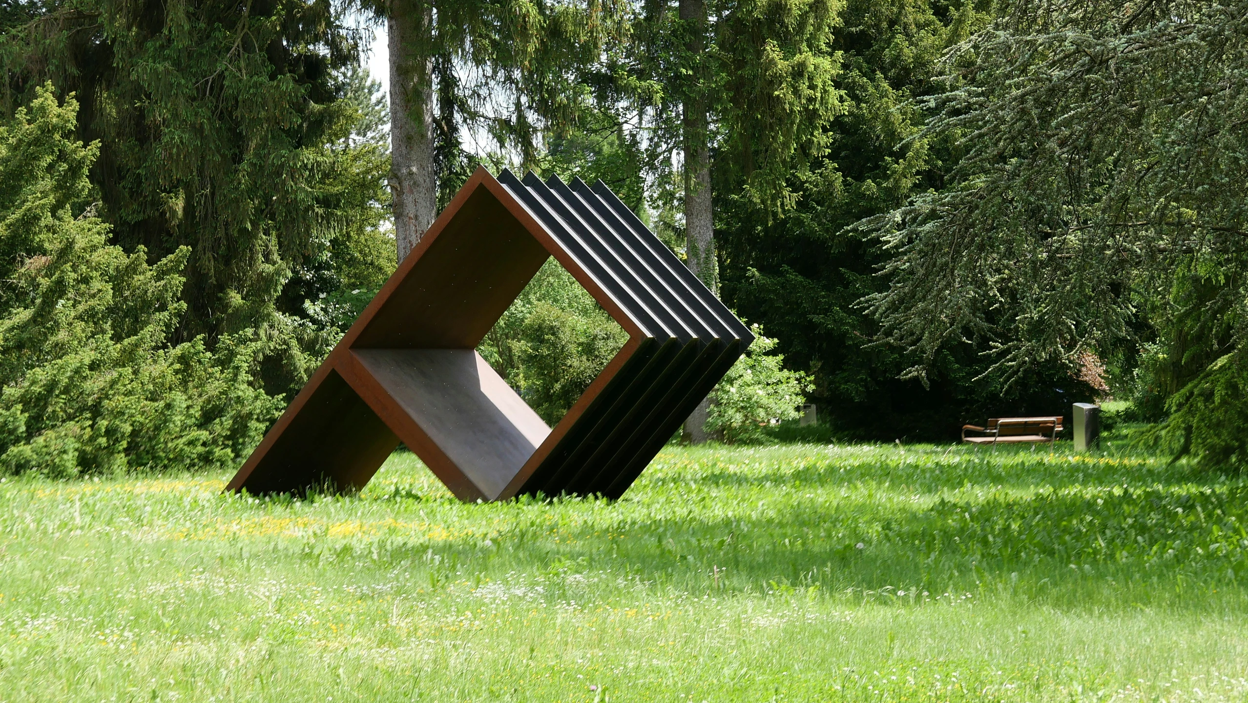 an abstract sculpture sitting in the middle of a forest