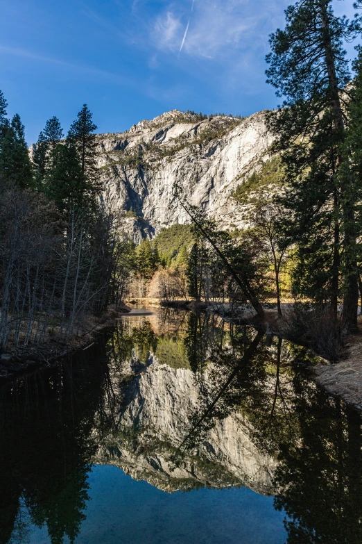 a mountain is behind a calm lake