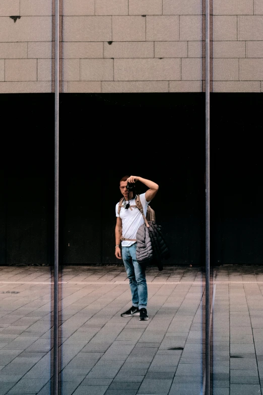 man standing in the middle of a walkway with his back to the camera