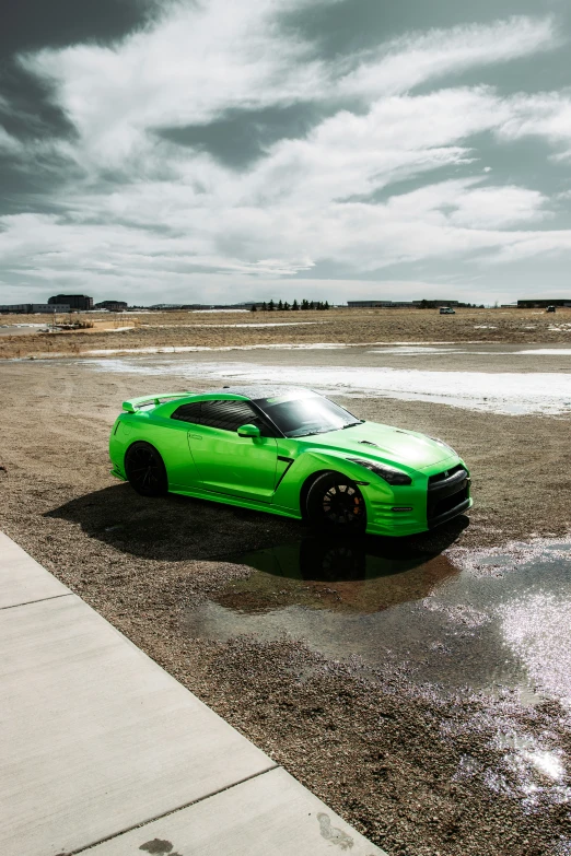 an all - green car on a wet, icy surface