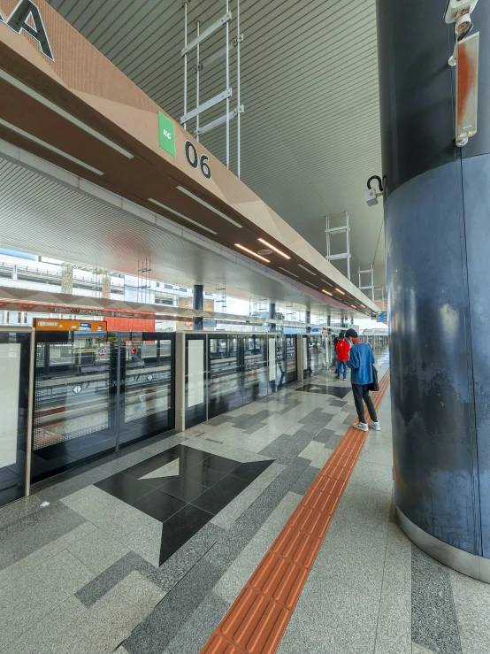 two people are walking down a concrete walkway