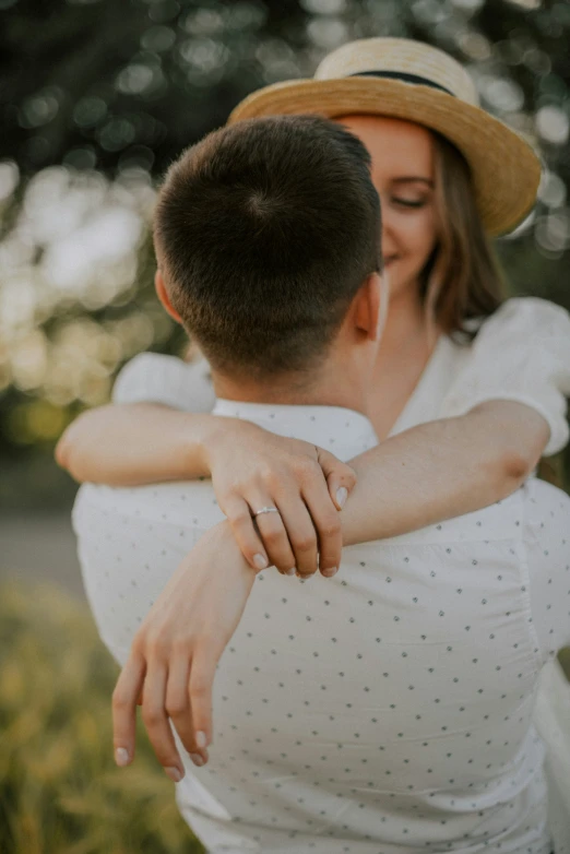 a woman is holding a man while he smiles