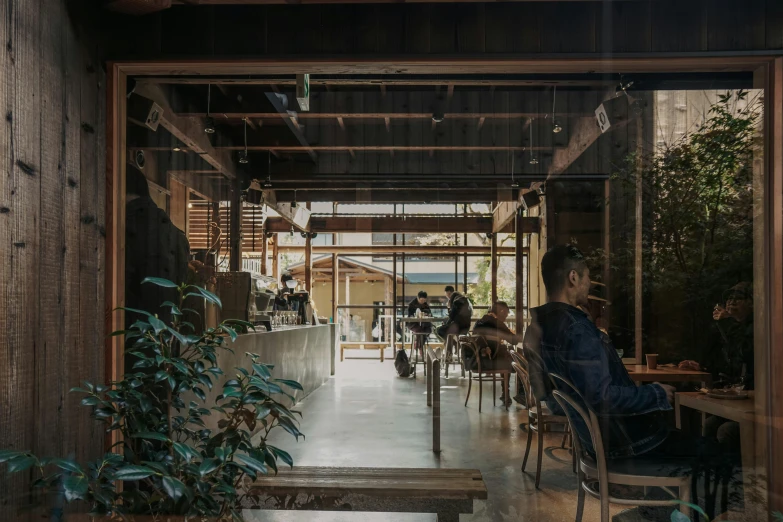 a person sitting at a table inside of a building