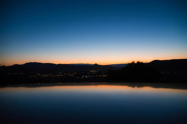 a lake that is empty with some trees and buildings