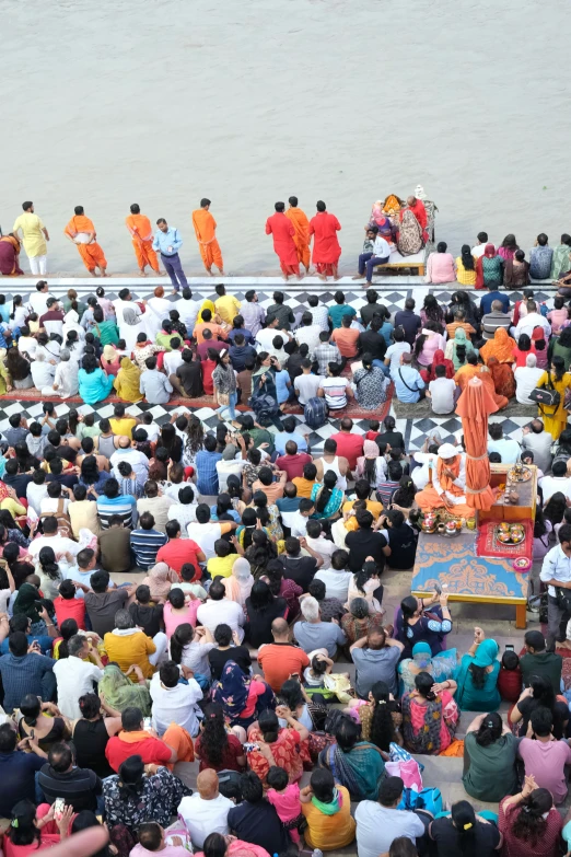 a large group of people sitting on the ground