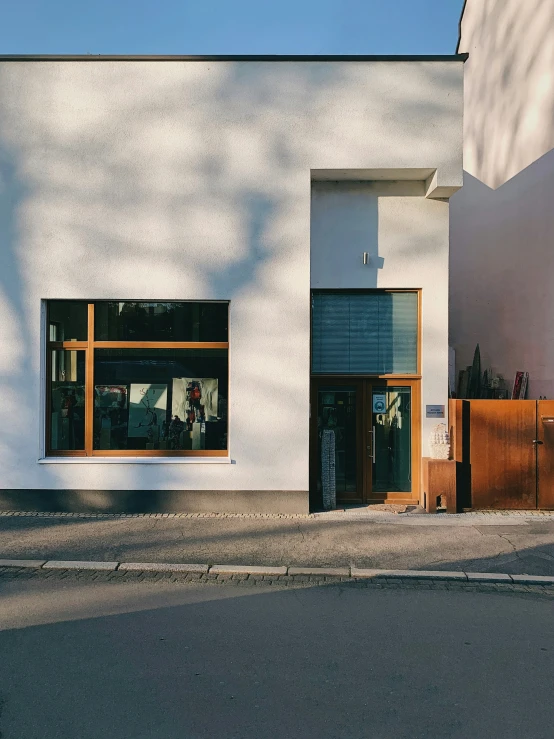 a white building with a large window and some signs outside of it