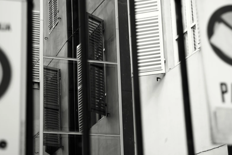 black and white pograph of several windows with shutters open