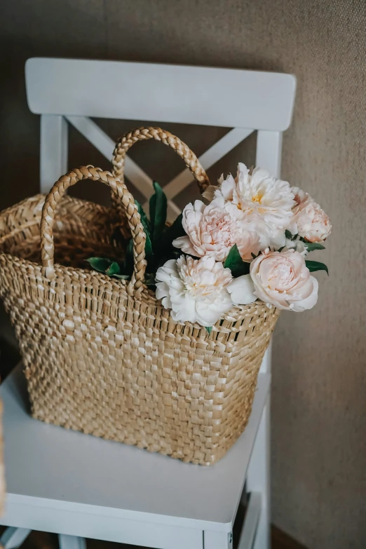 flowers in a basket on a chair in the corner