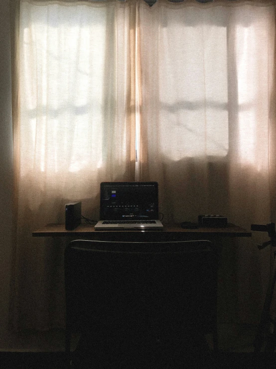 a desk and two light windows in a room