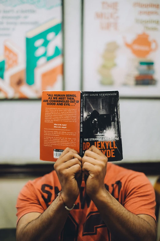 a man reads a book with an open pages in front of him