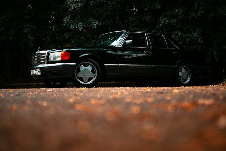 a black mercedes is parked on the road