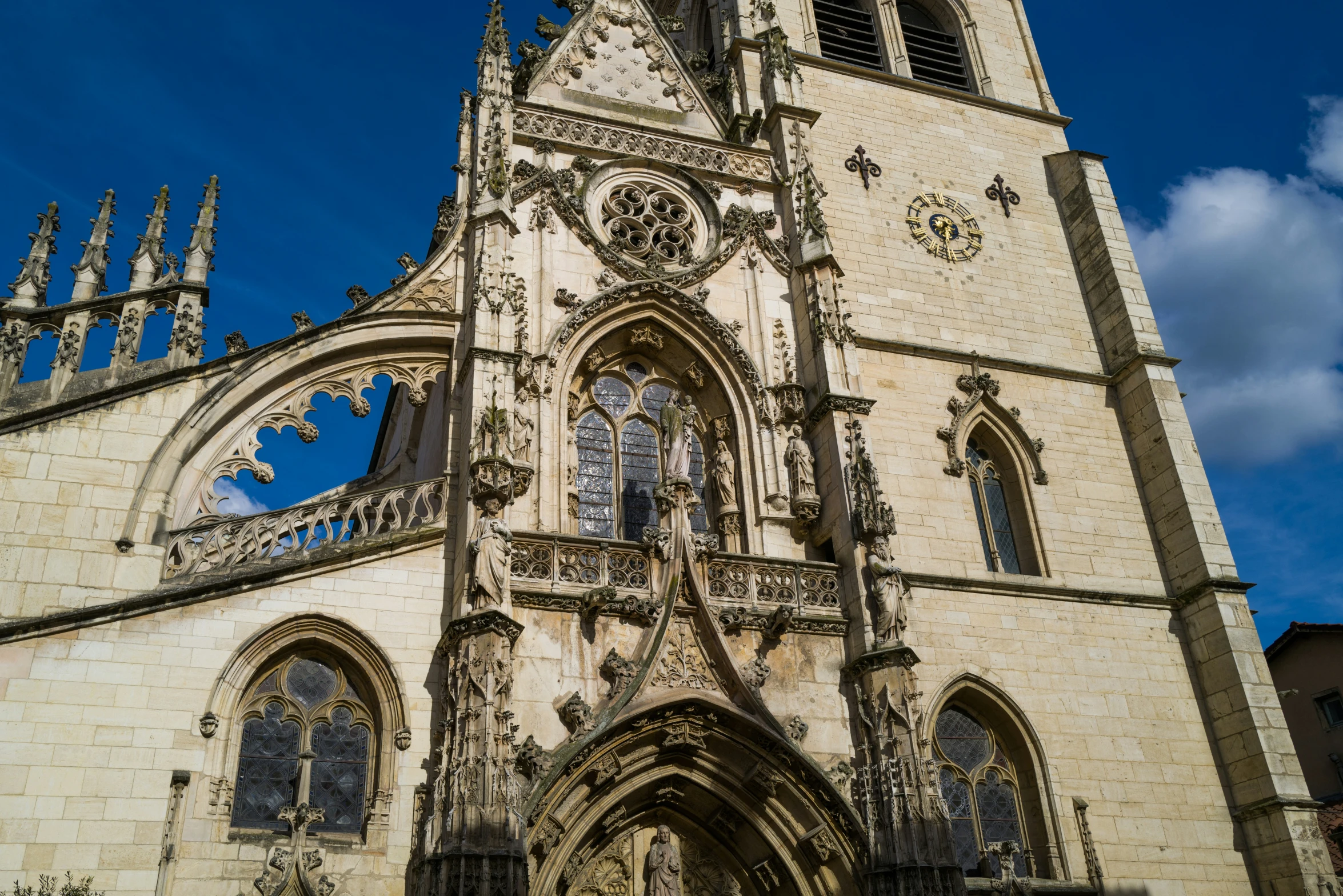 an old cathedral under a blue sky with clouds