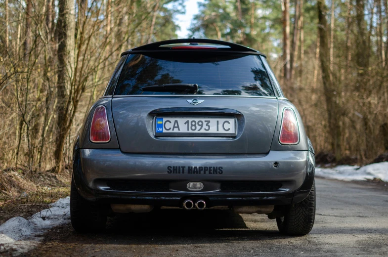 a silver car is on a narrow country road