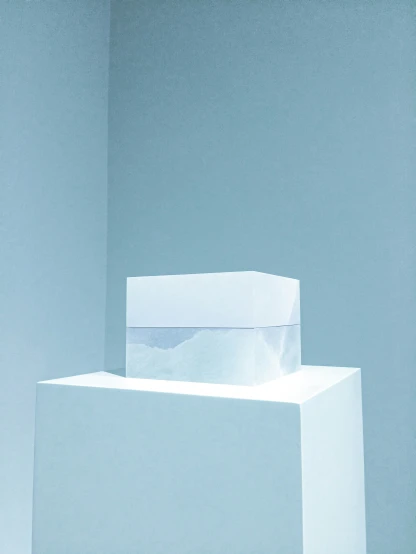 a white block standing against the wall with soing in it
