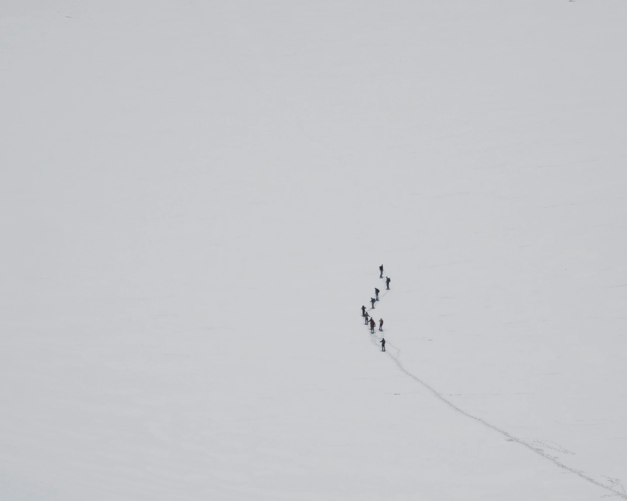 there are people standing in the snow on a trail