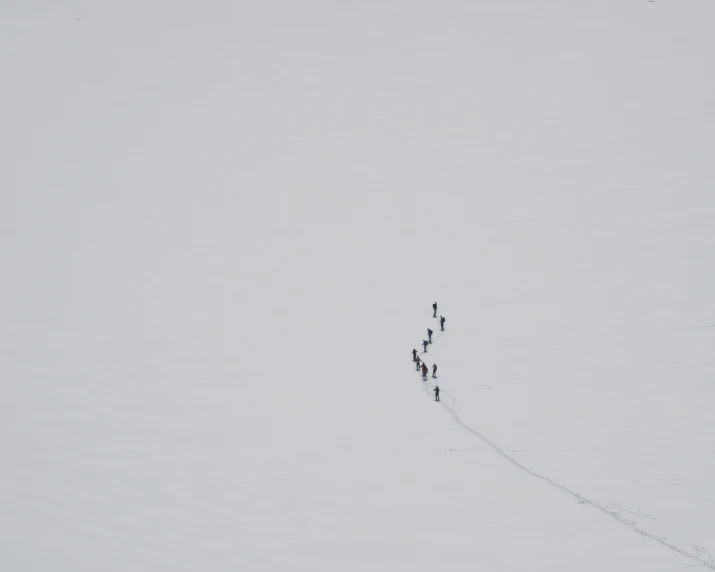 there are people standing in the snow on a trail