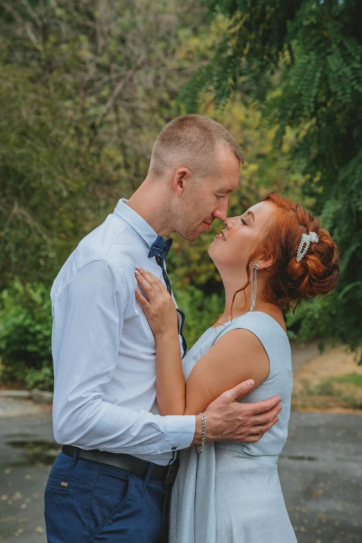 the couple is enjoying their intimate moment in the woods