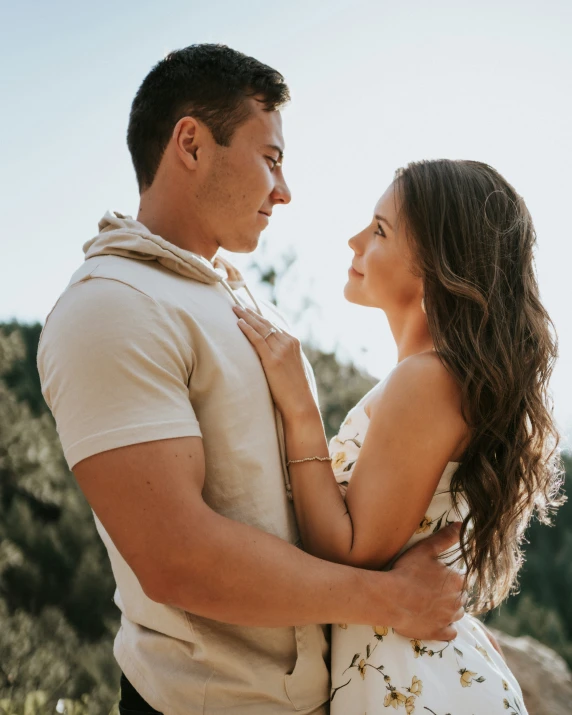 a man is hugging a woman in the sun