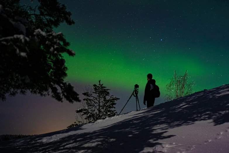 a person standing in the snow in the sky