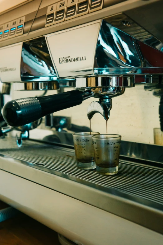 a coffee machine is pouring a cup of coffee