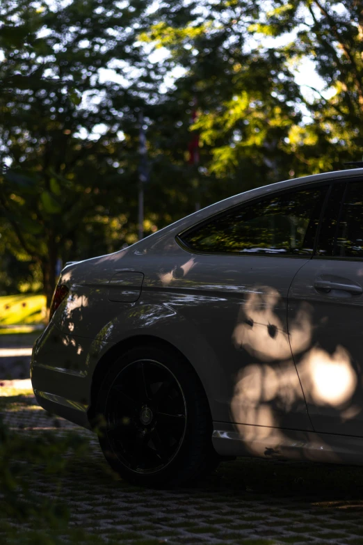 the shadow of a bike leaning on the back end of the car