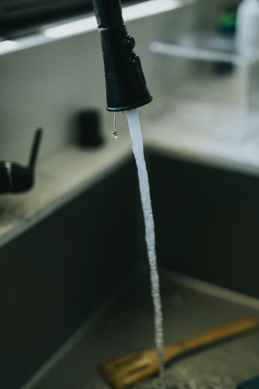 a black faucet that is dripping water from it