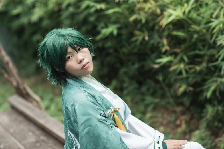 an asian boy with green hair dressed in an oriental style clothing