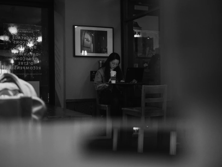 a woman is sitting on the corner of a house