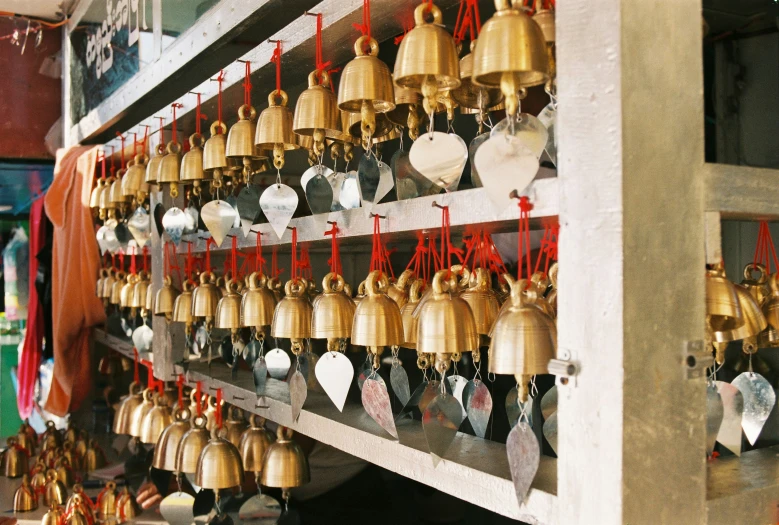 a group of bells hanging on the side of a building