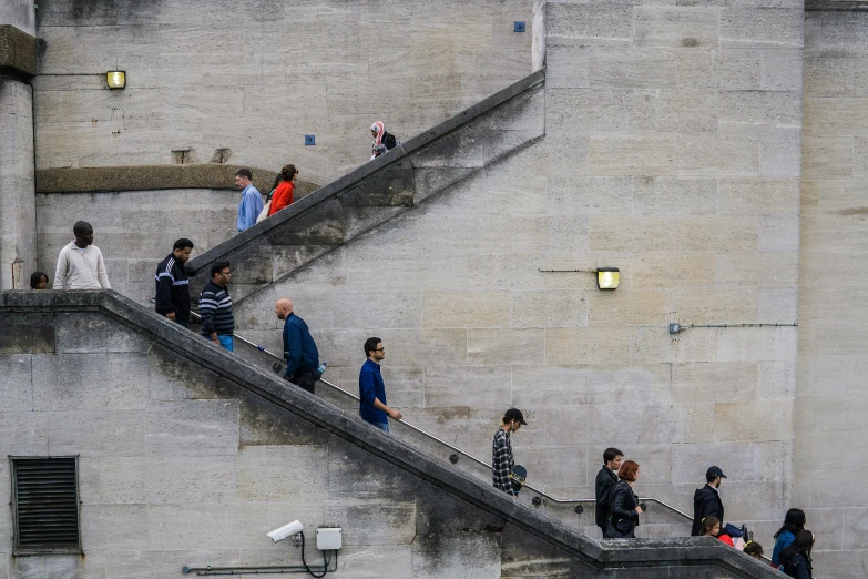 group of people climbing a set of stairs